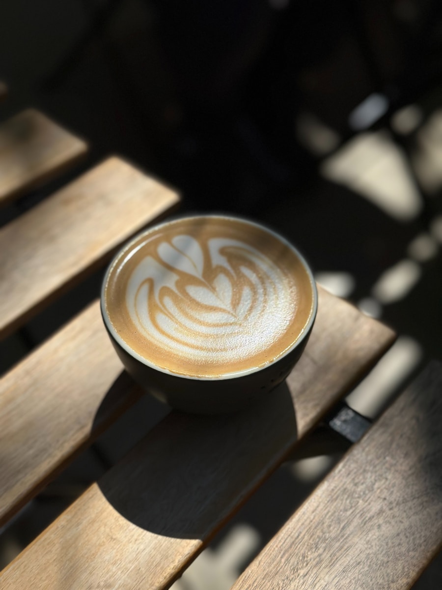 A cup of coffee sitting on top of a wooden table